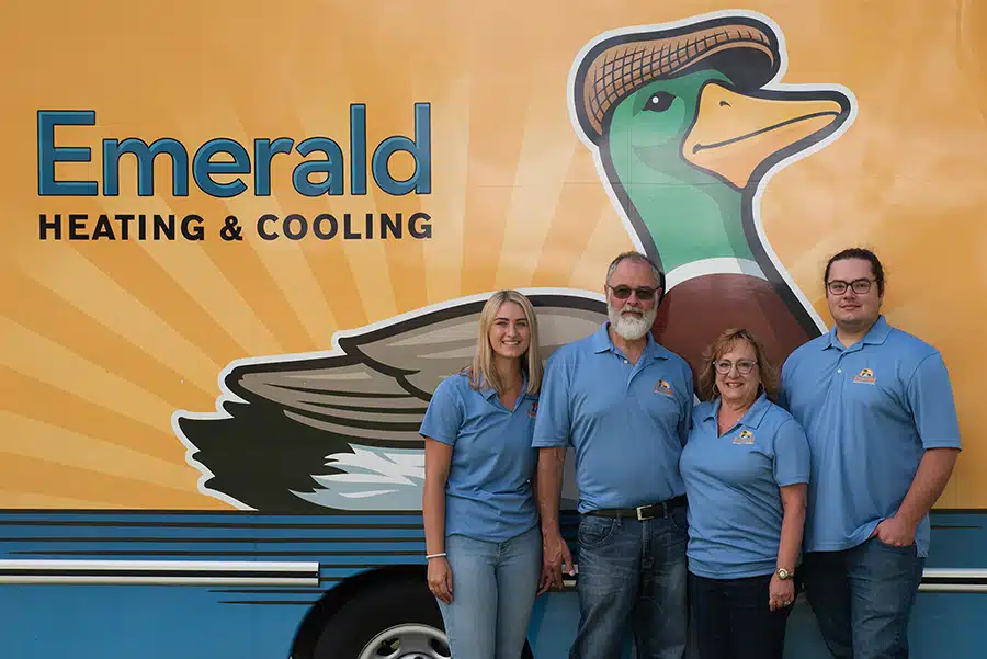 Emerald Heating and Cooling staff in front of fleet truck in Depew